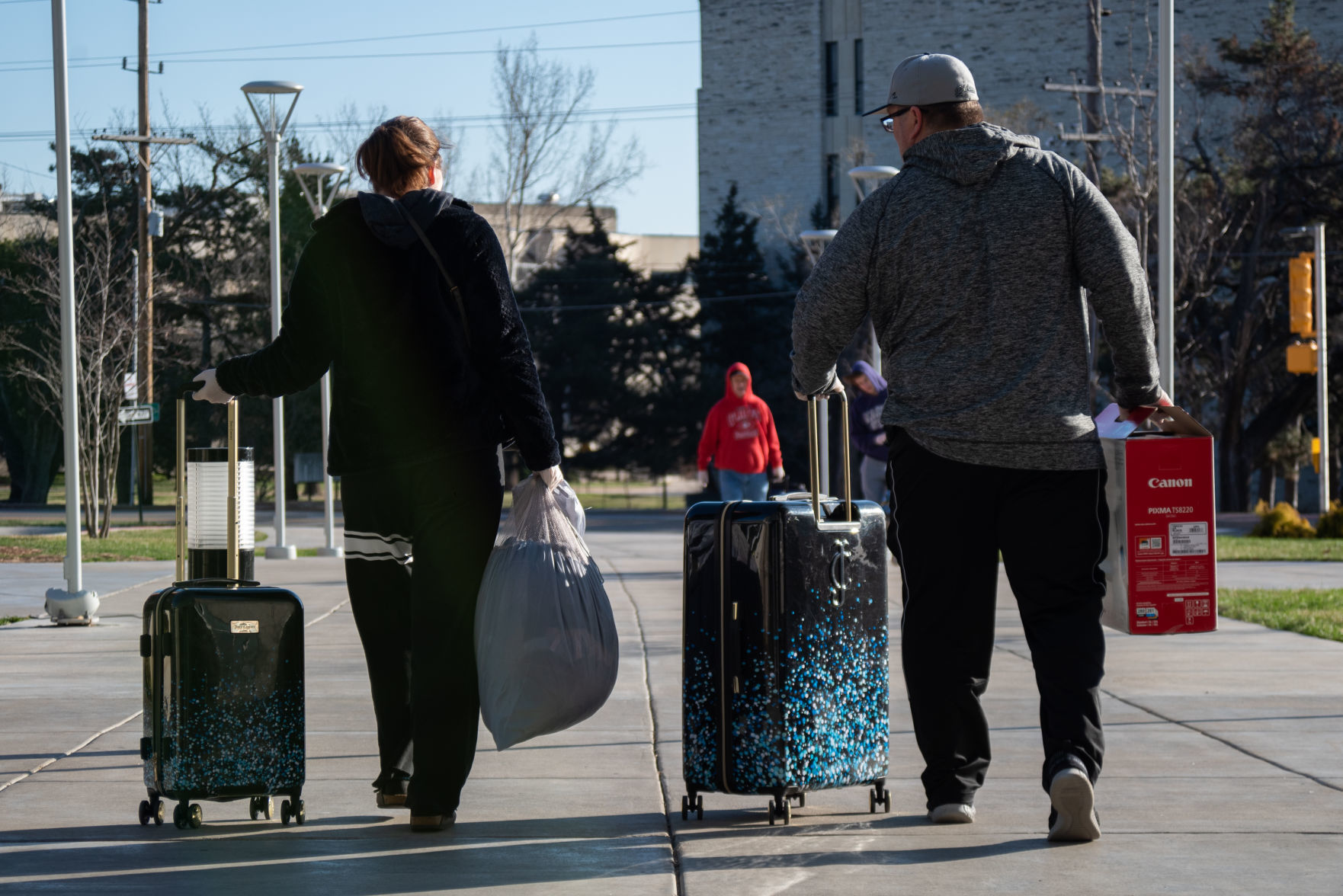 Paige Walker and Aaron Walker walk out of Wefald Hall with PaigeÕs belongings during their move-out slot on Friday.
